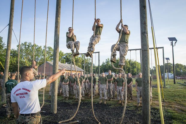 Marine candidates climb rope at Officer Candidate School.