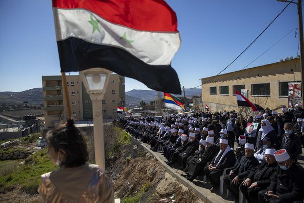 Syrian flags during a rally close to the Syrian border