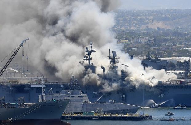 smoke rises from the USS Bonhomme Richard at Naval Base San Diego