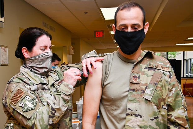 An Air Force master sergeant receives a COVID-19 vaccination.