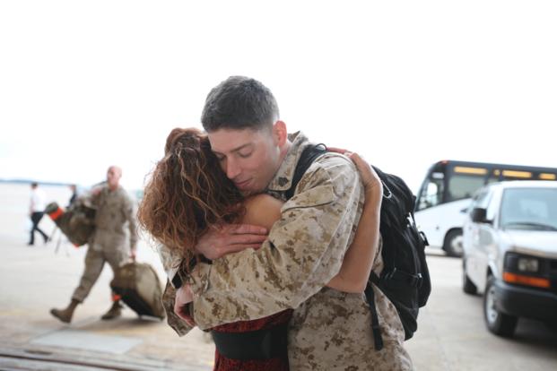 a marine hugs his wife after returning from deployment support
