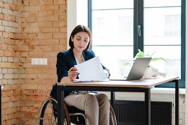 Woman in wheelchair working at desk