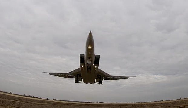 In this handout photo taken from video released by the Russian Defense Ministry Press Service on Wednesday, Nov. 10, 2021, a long-range Tu-22M3 bomber of the Russian Aerospace Forces takes off to patrol in the airspace of Belarus, Thursday, Nov. 11, 2021. (Russian Defense Ministry Press Service via AP) Russia Belarus Military