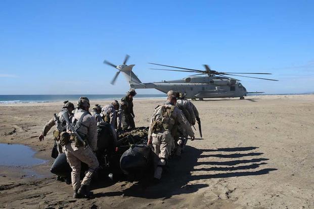 U.S. Marines load a combat rubber raiding craft for helocast operations
