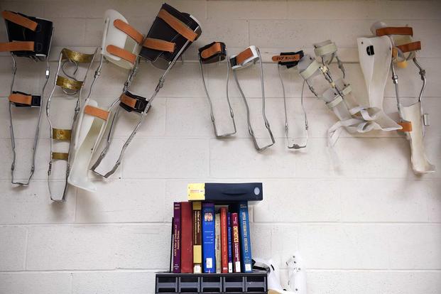 Leg braces created by former orthotics training students are displayed
