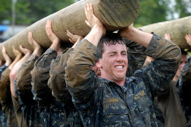 U.S. Naval Academy plebes carry a modified telephone pole during the log physical training station of Sea Trials. 