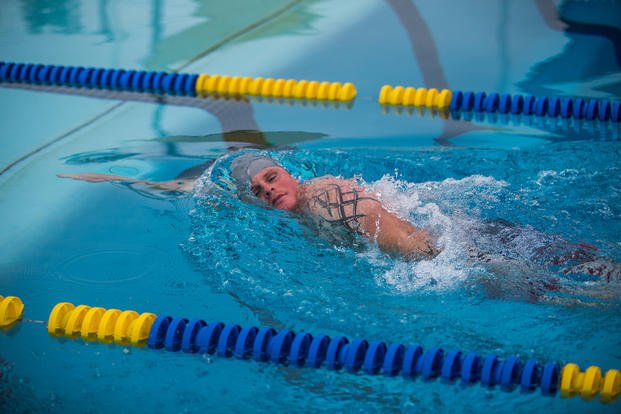 A Marine starts a 25-meter, side-stroke event.