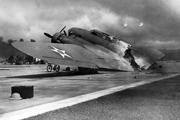 Wrecked Army Air Corps B-17C bomber near Hangar # 5 at Hickam Air Field, following the end of the Japanese raid. 