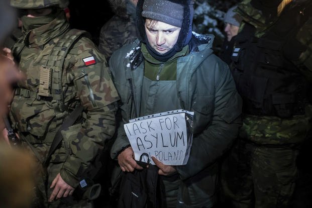 asylum seeker from Syria who has been taken into custody by Polish border guards
