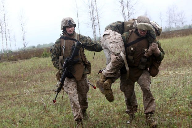 Marines practice a fireman carry during a convoy operation exercise.