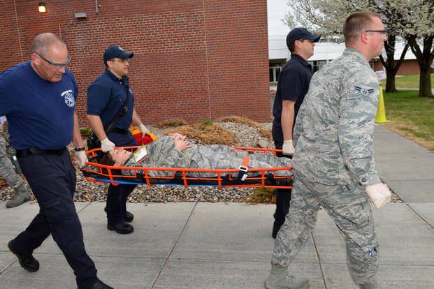 An Air National Guardsman is carried during an active shooter exercise.