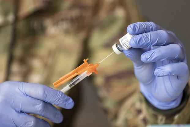 U.S. Army soldiers draw and prepare vaccines