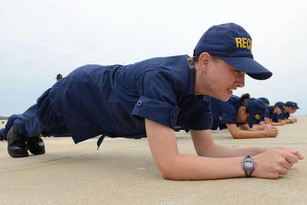 A Coast Guard recruit does plank exercises.