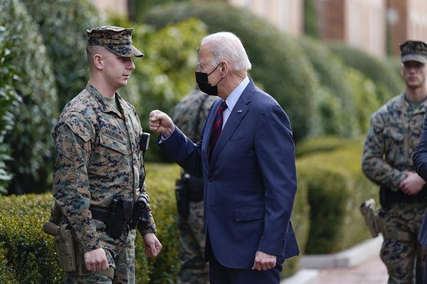 President Joe Biden visits a Marine outside the Marine Barracks Washington