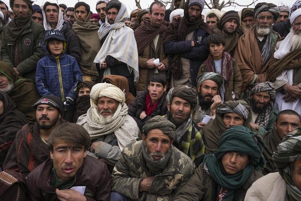 Afghan men gather to apply for humanitarian aid 