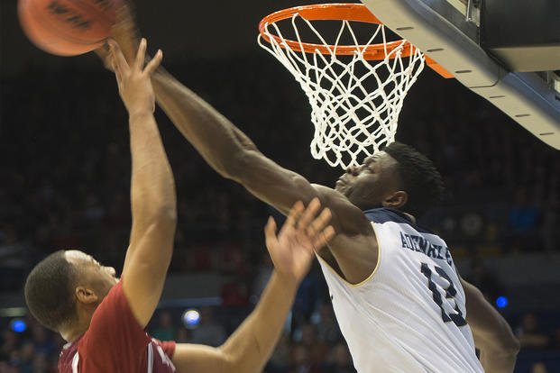 A UC Davis basketball player blocks a shot during an NCAA Tournament game. 