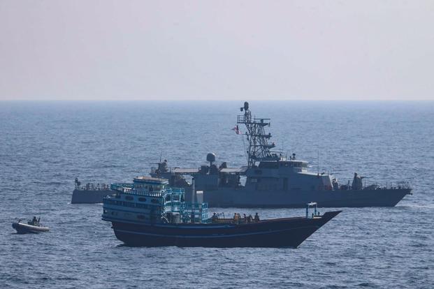U.S. service members conduct a boarding on a stateless fishing vessel transiting the Gulf of Oman. 