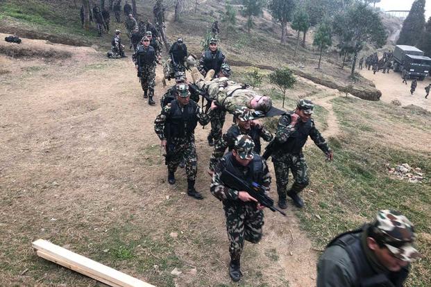 Soldiers from the Nepalese Army practice medically evacuating casualties