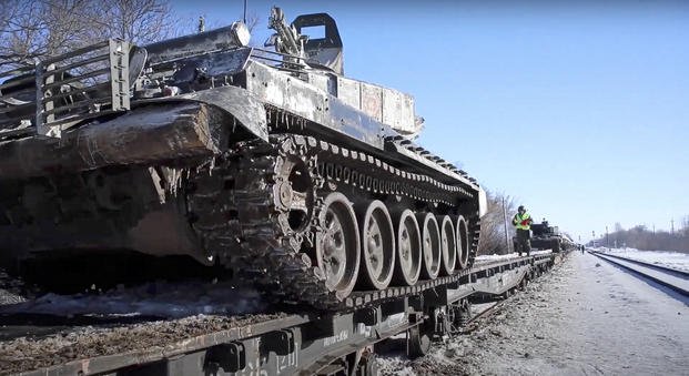 Russian army tanks are loaded onto railway platforms to move back to their permanent base