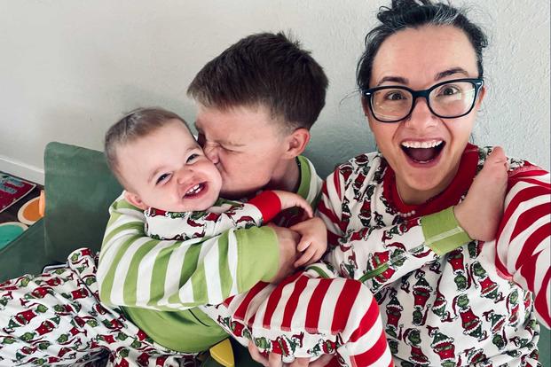 Navy Petty Officer Second Class Sam Rodriguez with their child and their wife