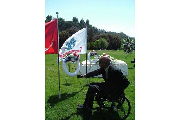 Sherman Gillums Jr. places a wreath at Fort Rosecrans National Cemetery.