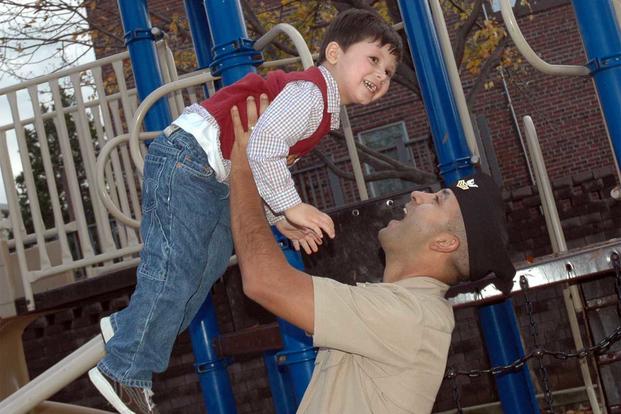 Sailor takes time to play with his son at a local park