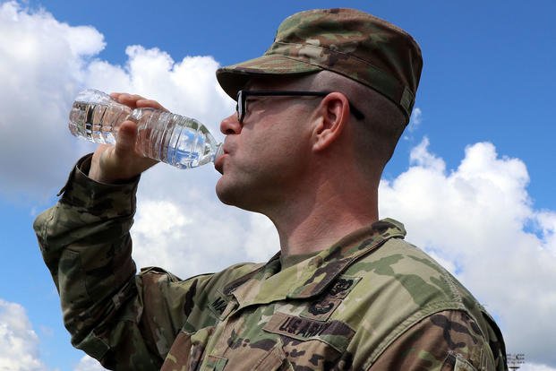 An Army staff sergeant drinks from a 16-ounce bottle of water.