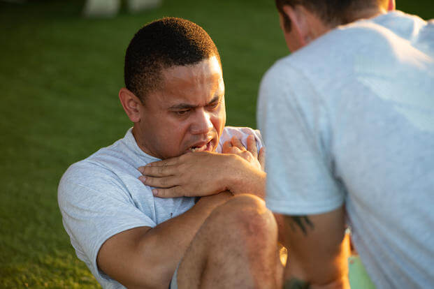 An Officer Training School trainee performs sit-ups during an Air Force physical training test.