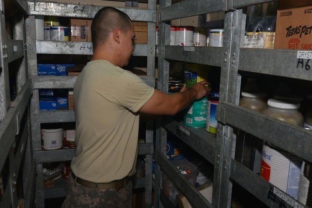 A food service specialist organizes supplies.
