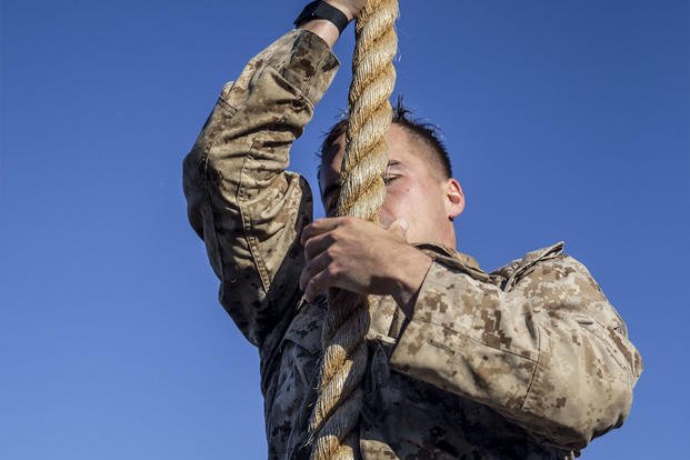 A Marine climbs down a rope during the 12th annual Recon Challenge.