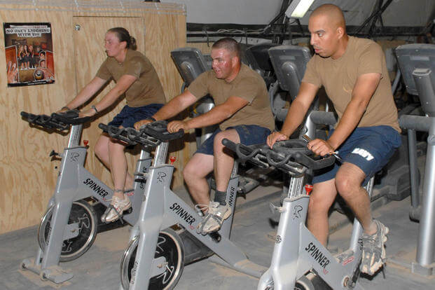 Seabees ride stationary bikes in the gym at Camp Natasha, Afghanistan.