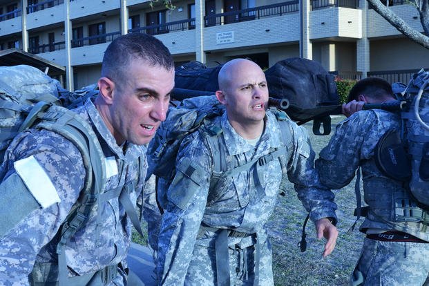 Special operations candidates march with extra weight during team day at Fort Hood.