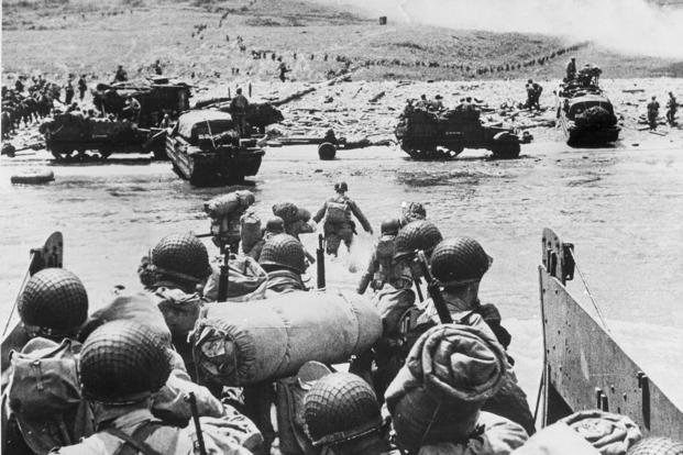 American soldiers and supplies arrive at Normandy.