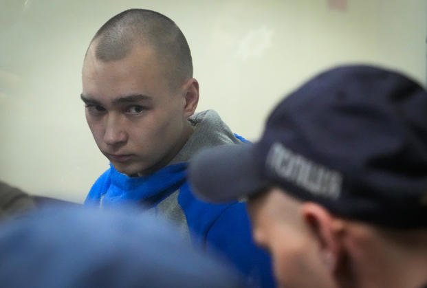Russian army Sergeant Vadim Shishimarin, 21, is seen behind a glass during a court hearing in Kyiv