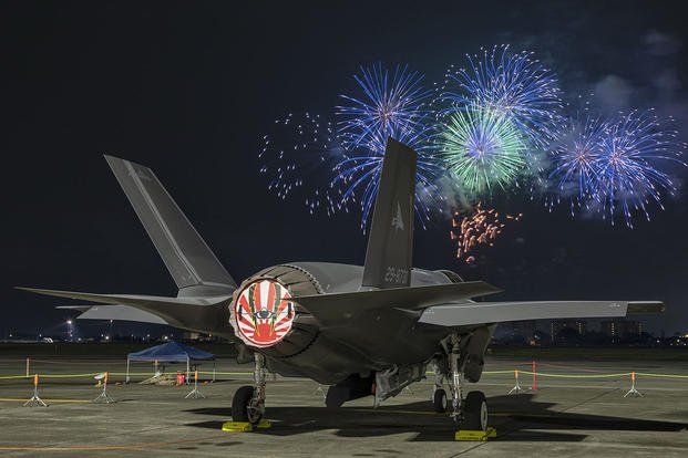 A Japan Air Self-Defense Force F-35A Lightning II Joint Strike Fighter sits at Yokota Air Base during a fireworks display. 