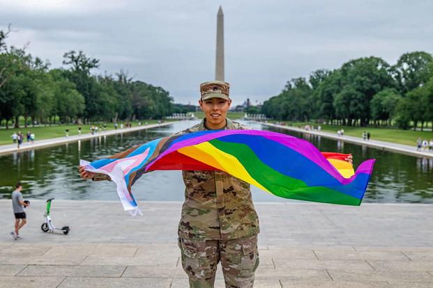 Sgt. Claudia Villegas poses in front of the Lincoln Memorial Reflecting Pool and Washington Monument.