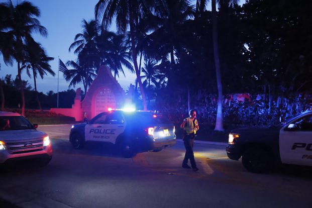 Police direct traffic outside an entrance to former President Donald Trump's Mar-a-Lago estate