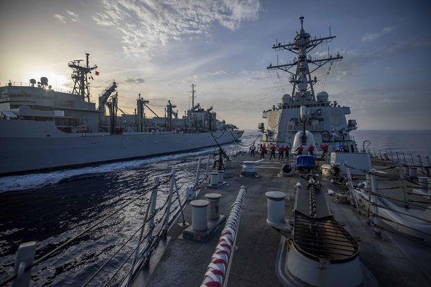 The Arleigh Burke-class guided-missile destroyer USS Arleigh Burke (DDG 51) conducts a replenishment-at-sea with the Supply-class fast combat support ship USNS Supply (T AOE 6).