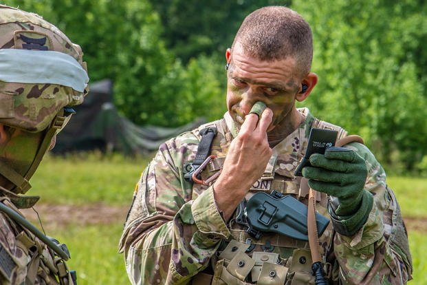 U.S. Army Forces Command’s Command Sgt. Maj. Michael A. Grinston applies camouflage face paint at Fort Campbell, Kentucky.