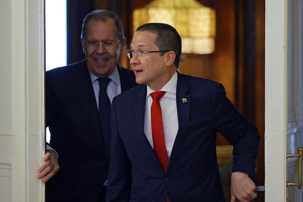 Russian Foreign Minister Sergey Lavrov, left, and Venezuelan Foreign Minister Carlos Faria enter a hall for their talks in Moscow.
