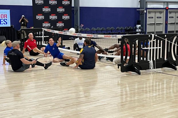 Adaptive sports athletes set to compete in the Warrior Games demonstrate sitting volleyball in an arena at Walt Disney World. The Warrior Games are scheduled for Aug. 19-28 near Orlando, Florida.