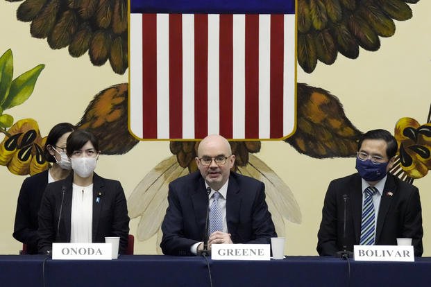 U.S. Deputy Chief of Mission Raymond Greene, center, delivers a speech