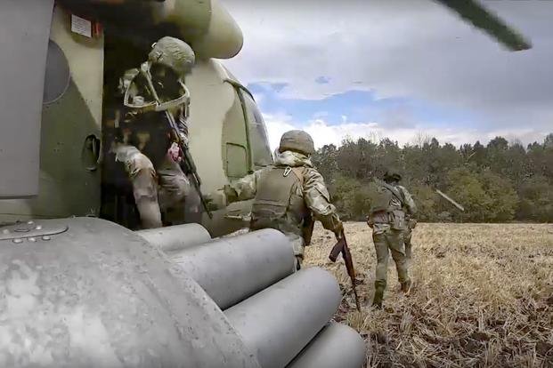 , Russian Army soldiers leave a military helicopter.