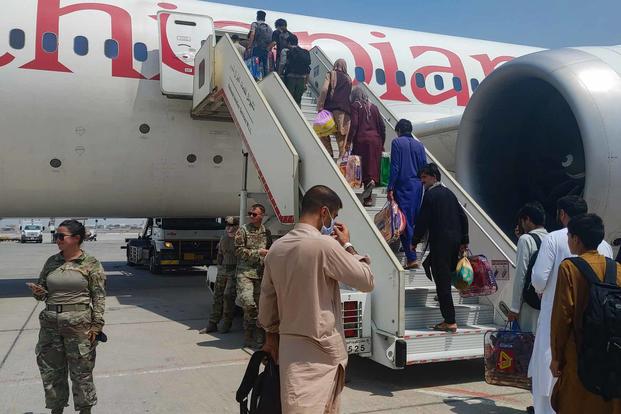 Afghan evacuees at Abdullah Al Mubarak Air Base in Kuwait City.