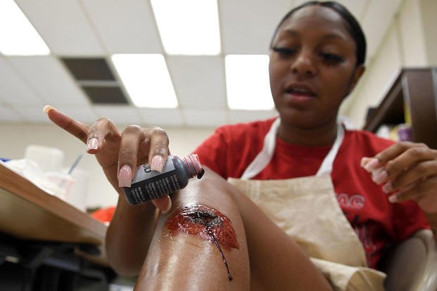 U.S. Air Force Airman 1st Class Marissa Stove, 81st Diagnostic and Therapeutics Squadron diet technician, applies moulage to her leg during moulage training at Keesler Air Force Base, Mississippi, Sept. 28, 2022. (Kemberly Groue/U.S. Air Force photo)