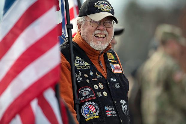 A veteran smiles at a ceremony.