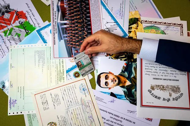 In his home in Houston, Sami-ullah Safi sorts through dozens of certificates and photos