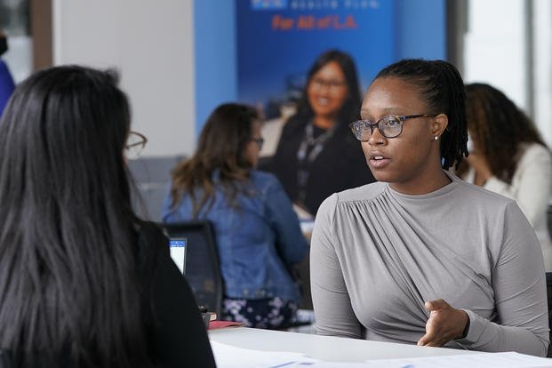 Job candidate Maya Williams, right, is interviewed for a health care customer service position at the L.A. Care Health Plan job fair at the company's office in downtown Los Angeles on Saturday, May 21, 2022. (Damian Dovarganes/AP Photo)