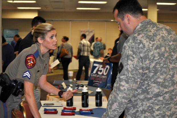 Texas Department of Public Safety Cpl. Arminda Henke meets with Sgt. 1st Class Christian Garcia at the Hiring Heroes Career Fair at Joint Base San Antonio.