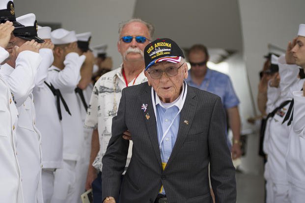 Pearl Harbor survivor Donald Stratton is saluted as he attends the dual interment of fellow USS Arizona shipmates John D. Anderson and Clarendon R. Hetrick at the USS Arizona Memorial in Pearl Harbor, Hawaii.